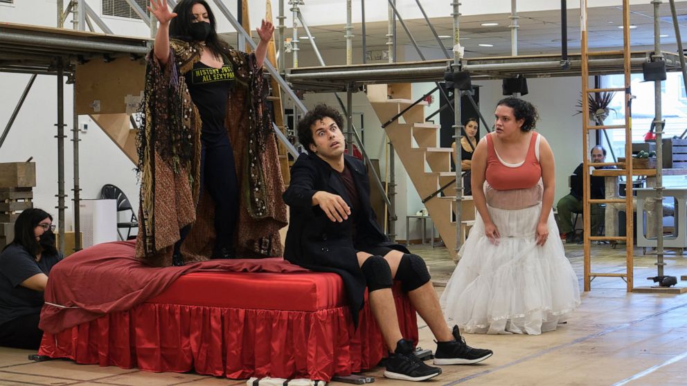 Actors Maria Christina-Oliveras, standing from left, Joel Perez and Desireé Rodriguez rehearse a scene from the musical comedy “Kiss My Aztec!” in Hartford, Conn., on May 12, 2022. The show, co-written by John Leguizamo and director Tony Taccone, wil