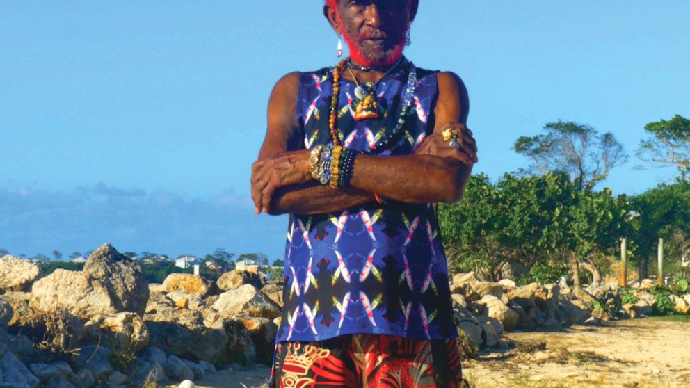 FILE - This 2018 file photo provided by Megawave shows "Lee Scratch" Perry, whose real name is Rainford Hugh Perry, in Negril, Jamaica. The Jamaican singer and record producer, considered one of reggae’s founding fathers, died on Aug. 29, 2021 at a h
