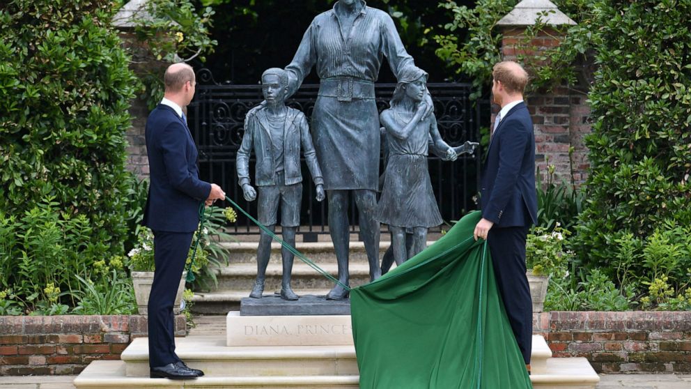 Britain's Prince William, left and Prince Harry unveil a statue they commissioned of their mother Princess Diana, on what woud have been her 60th birthday, in the Sunken Garden at Kensington Palace, London, Thursday July 1, 2021. (Dominic Lipinski /P