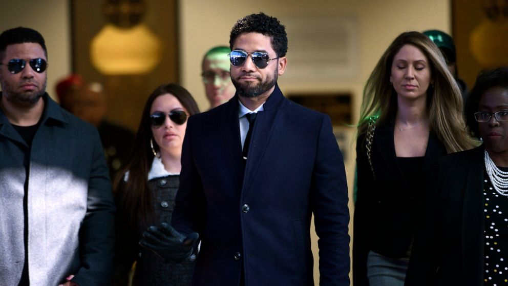 FILE - In this March 26, 2019 file photo, actor Jussie Smollett gestures as he leaves Cook County Court after his charges were dropped in Chicago. Smollett faces new charges for reporting an attack that Chicago authorities contend was staged to garne