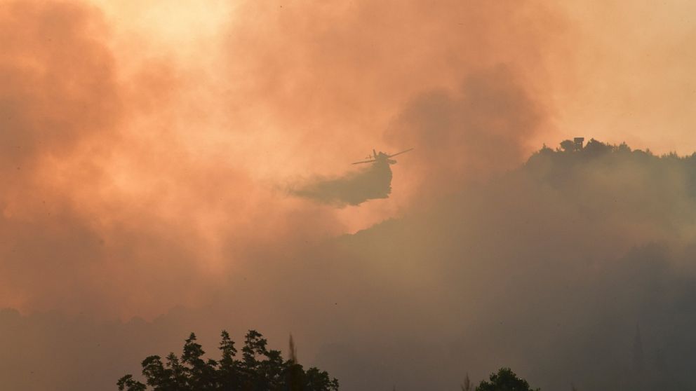Forest fires rage in Greece, threaten Olympics birthplace