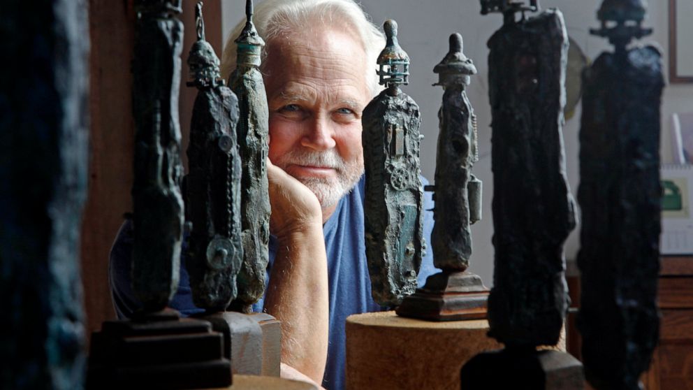 FILE - Tony Dow, actor, director and artist, poses with some of his works at his home and studio in the Topanga area of Los Angeles, Thursday, Sept. 18, 2012. “Leave It to Beaver” actor Dow has died at age 77. Frank Bilotta, who represented Dow in hi
