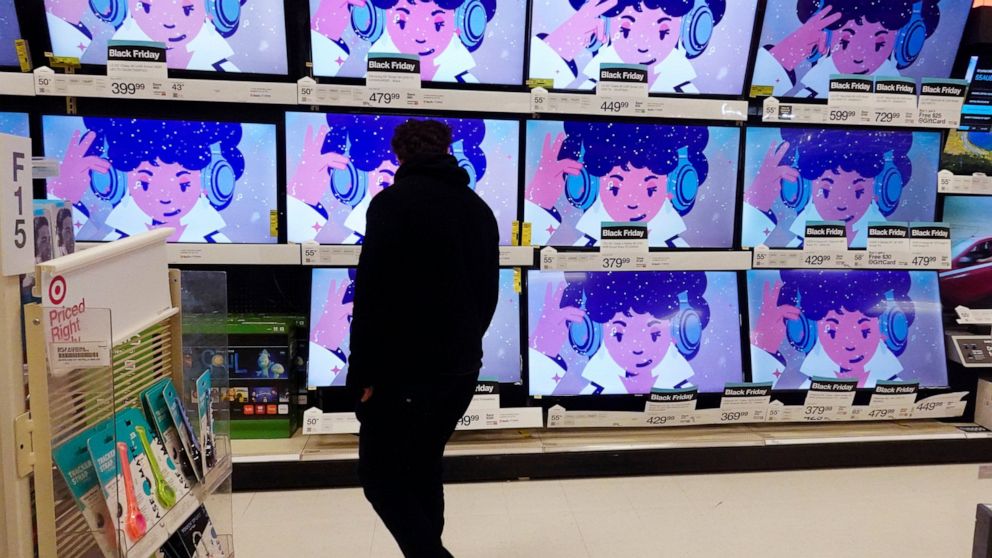 FILE - A shopper looks at televisions in a store in Indianapolis on Friday, Nov. 26, 2021. Nielsen shares tumbled Monday, March 21, 2022, after the TV ratings and marketing data company’s board rejected a $9 billion private equity takeover bid. (AP P