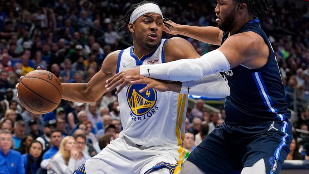 Golden State Warriors guard Moses Moody (4) drives past Dallas Mavericks guard Jalen Brunson, right, during the second half of Game 3 of the NBA basketball playoffs Western Conference finals, Sunday, May 22, 2022, in Dallas. (AP Photo/Tony Gutierrez)