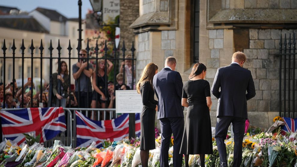Britain's Prince William and Kate, Princess of Wales and Britain's Prince Harry and Meghan, Duchess of Sussex view the floral tributes for the late Queen Elizabeth II outside Windsor Castle, in Windsor, England, Saturday, Sept. 10, 2022. (AP Photo/Ma