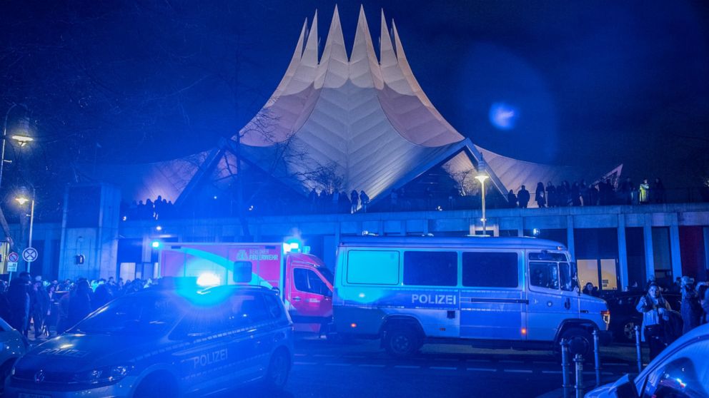 Police and emergency cars stand in front of the Tempodrom venue after a shooting in Berlin, Germany, early Saturday, Feb. 15, 2020. According to police one person was killed. (Paul Zinken/dpa via AP)