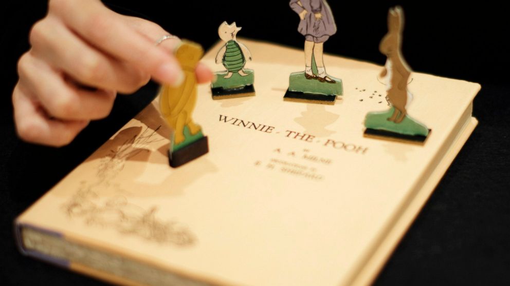 FILE - A first U.S. edition of Winnie the Pooh signed by the author A.A. Milne and illustrator E.H. Shepard is displayed with cut-outs representing characters from the book at offices of the Sotheby's auction house in London, Monday, Dec. 15, 2008. “