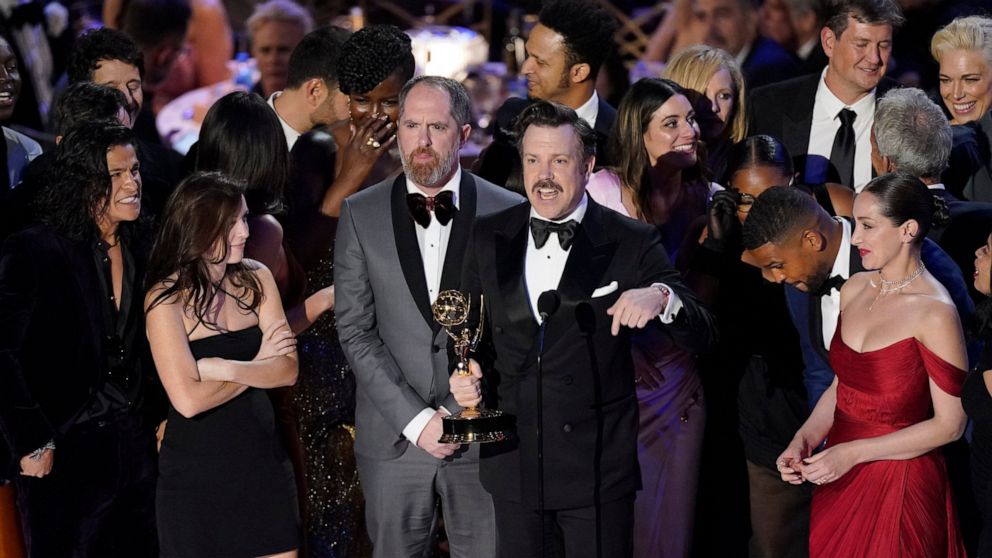 Jason Sudeikis, center, and the cast of "Ted Lasso" accept the Emmy for outstanding comedy series at the 74th Primetime Emmy Awards on Monday, Sept. 12, 2022, at the Microsoft Theater in Los Angeles. (AP Photo/Mark Terrill)
