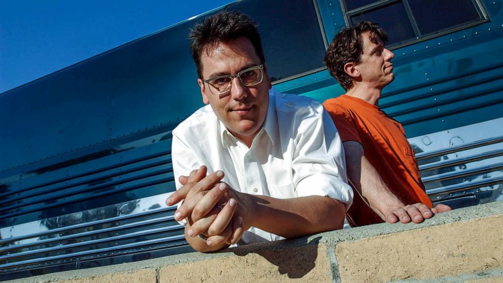 FILE - John Flansburgh, left, and John Linnell, members of the musical group They Might Be Giants, pose in front of their tour bus outside the John Anson Ford Theater in Los Angeles July 26, 2002. Flansburgh is recovering after being seriously injure