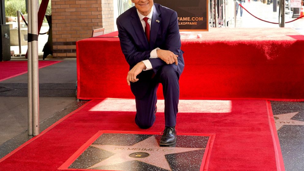 FILE - Mehmet Oz, the former host of "The Dr. Oz Show," poses atop his new star on the Hollywood Walk of Fame during a ceremony on Feb. 11, 2022, in Los Angeles. Oz may have made his reputation as a surgeon. But he made a fortune as a salesman on day