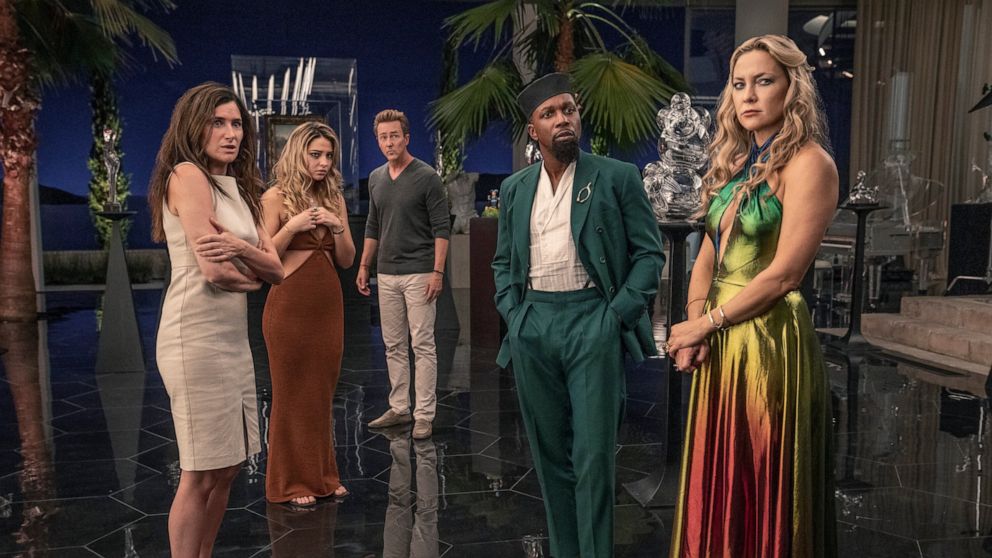 This image released by Netflix shows Kathryn Hahn, from left, Madelyn Cline, Edward Norton, Leslie Odom Jr. and Kate Hudson in a scene from "Glass Onion: A Knives Out Mystery." (John Wilson/Netflix via AP)