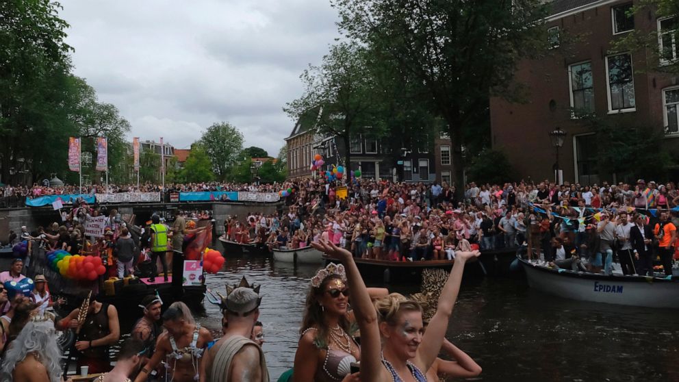 People take part in the Amsterdam Pride Parade, in Amsterdam, Netherlands, Saturday, Aug. 3, 2019. Tens of thousands of spectators are lining one of Amsterdam’s main canals to watch a flotilla of decorated boats make their way through the historic wa