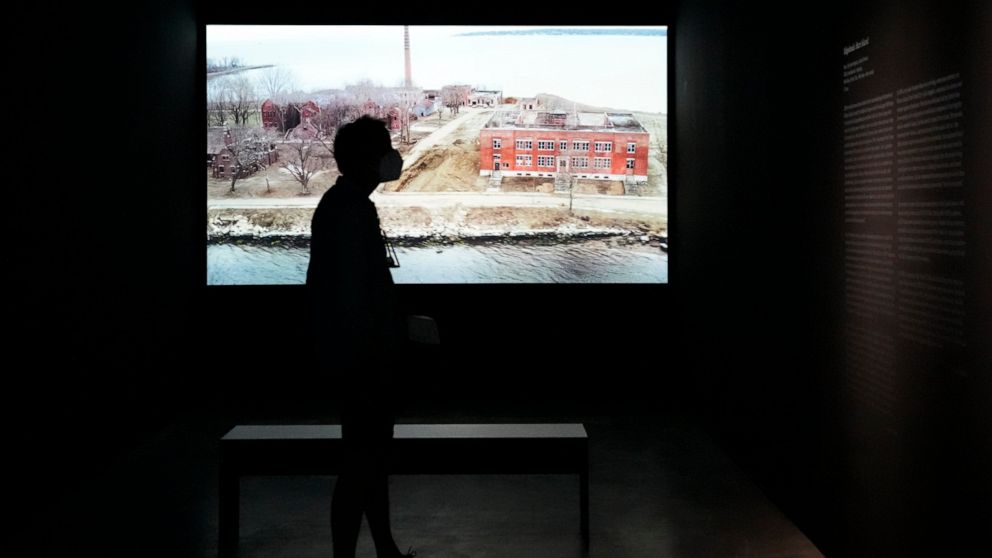 A man stands in front of the artwork 'Hart Island", by Laura Poitras in collaboration with Sean Vegezzi, at an exhibition by American artist and filmmaker Laura Poitras, at the N.K.B. gallery in Berlin, Germany, on Friday, June 18, 2021. The exhibiti