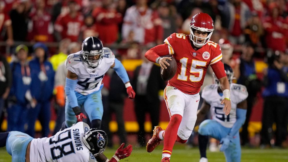 Kansas City Chiefs quarterback Patrick Mahomes (15) runs with the ball past Tennessee Titans defensive tackle Jeffery Simmons (98), safety Andrew Adams (47) and linebacker David Long Jr. (51) during the second half of an NFL football game Sunday, Nov