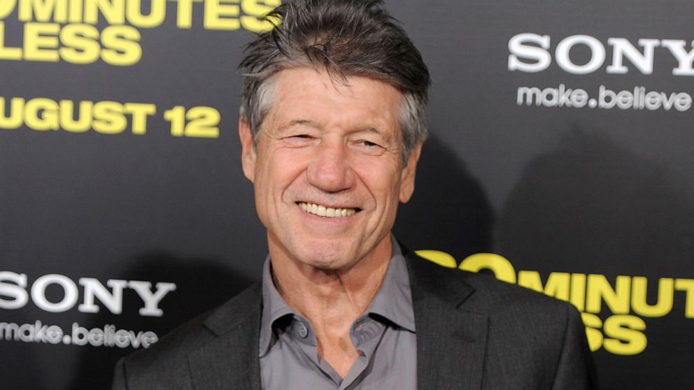 FILE - Fred Ward, a cast member in "30 Minutes or Less," poses at the premiere of the film in Los Angeles on Aug. 8, 2011. Ward, a veteran actor who brought a gruff tenderness to tough-guy roles in such films as “The Right Stuff,” “The Player” and “T