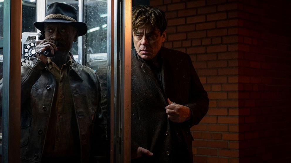 This image released by Warner Bros. Entertainment shows Don Cheadle, left, and Benicio Del Toro in a scene from "No Sudden Move." (Claudette Barius/Warner Bros. Entertainment via AP)