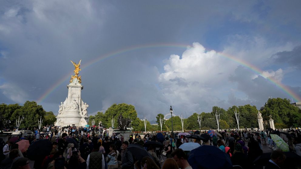 People gather outside Buckingham Palace in London, Thursday, Sept. 8, 2022. Buckingham Palace says Queen Elizabeth II has been placed under medical supervision because doctors are "concerned for Her Majesty's health." Members of the royal family trav