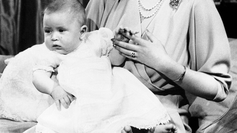 FILE - In this April 10, 1949 file photo, Prince Charles of Edinburgh, left, sits for a photo with his mother, Princess Elizabeth, in Buckingham Palace, London. Prince Charles has been preparing for the crown his entire life. Now, that moment has fin