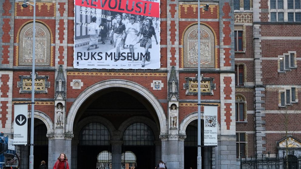 An external view of the National Museum in Amsterdam with a poster advertising the show, “Revolusi! Indonesia Independent”, Wednesday, Feb. 9, 2022. A new exhibition opens this week at the Dutch national museum that examines the violent birth of the 