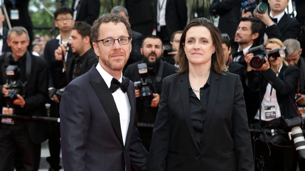 FILE - Ethan Coen, left, and Tricia Cooke at the 68th international film festival, Cannes, southern France, Saturday, May 23, 2015. Most in the film industry thought Ethan Coen was done with movies. Ethan did, too. But on Sunday, Coen will premiere h