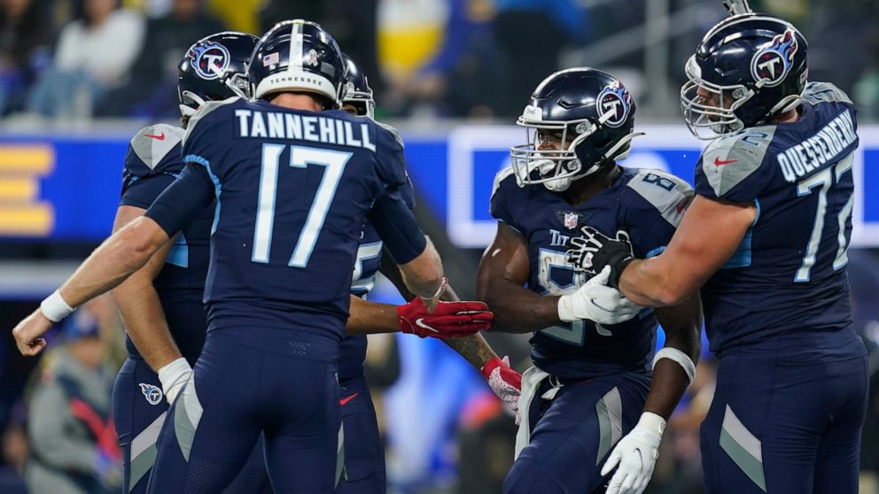 Tennessee Titans running back Adrian Peterson, second from right, celebrates with teammates quarterback Ryan Tannehill (17), offensive tackle David Quessenberry, right, and others after scoring a touchdown during the second half of an NFL football ga