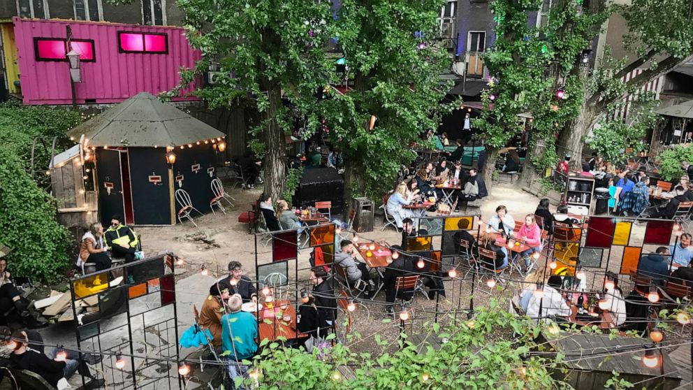 This Saturday May 22, 2021 taken photo shows people sitting at the 'Wilde Renate' beer garden in Berlin, Germany. Several of the German capital's nightspots have managed a limited restart along with pubs and restaurants over Pentecost weekend. (AP Ph