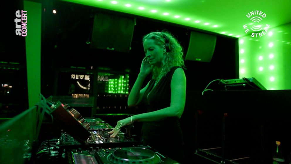 In this March 18, 2020, frame from video provided by Rundfunk Berlin-Brandenburg, DJ Monika Kruse performs a set as part of the “United We Stream” event at the club Watergate in Berlin. Berlin's nightclubs were closed March 13 to help slow the spread