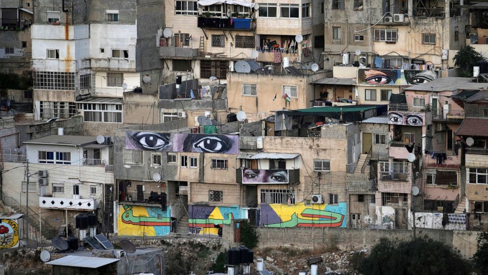 Murals that are part of the public art project 'I Witness Silwan' depicting the eyes of local and international figures, including George Floyd, a Black American killed by police, top right, in the Silwan neighbourhood of east Jerusalem, Friday, Aug.