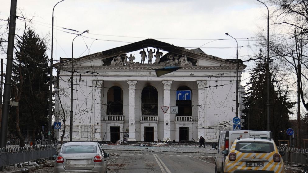 FILE - People walk past the Donetsk Academic Regional Drama Theatre in Mariupol, Ukraine, following a March 16, 2022, bombing of the theater, which was used as a shelter, in an area now controlled by Russian forces on April 4, 2022. Russian troops in