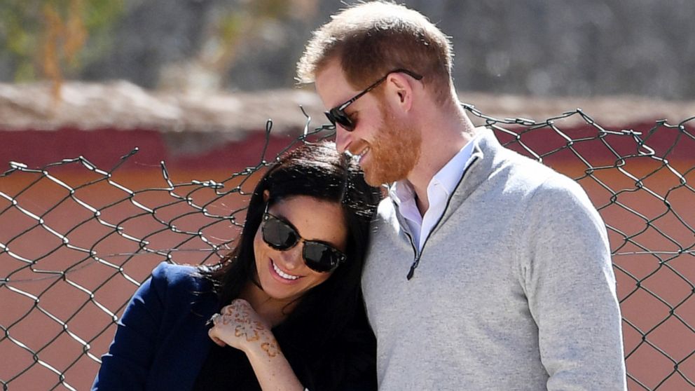 FILE - In this Sunday, Feb. 24, 2019 file photo, Britain's Prince Harry and Meghan, Duchess of Sussex, watch children playing football at a school in the town of Asni, in the Atlas mountains, Morocco. Buckingham Palace said Monday May 6, 2019, that P