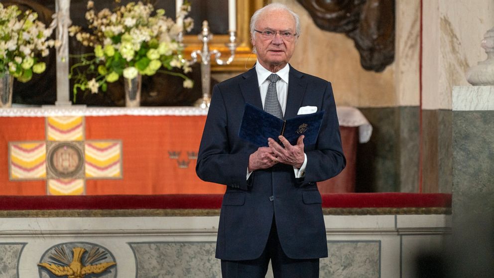 Sweden's King Carl Gustaf reads a text during a Memorial service at Drottningholm Palace Church in Stockholm, Thursday, March 11, 2021. Sweden’s King Carl XVI Gustaf and his wife Queen Silvia held a church ceremony on Thursday to honour the victims o