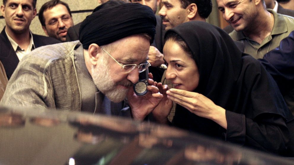 FILE - In this July 13, 2005, file photo, outgoing reformist Iranian President Mohammad Khatami talks on the phone with the mother of female journalist Masih Alinejad, right, after meeting with journalists in Tehran, Iran. Prosecutors in the U.S. all
