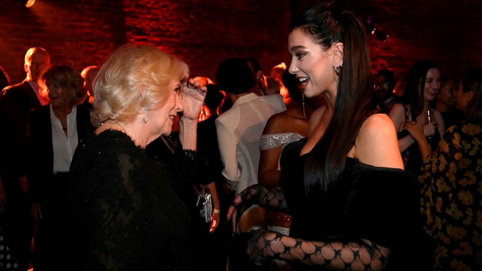Britain's Camilla, Queen Consort talks with Dua Lipa, right, during the Booker Prize at the Roundhouse in London, Monday Oct. 17, 2022. (Toby Melville/Pool via AP)