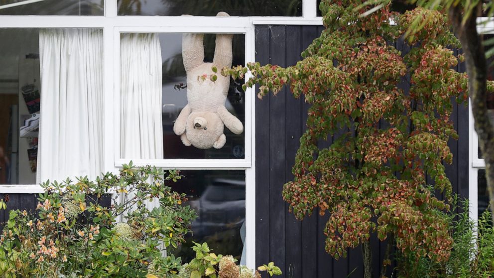 In this Monday, March 30, 2020, photo, a teddy bear hangs upside down in a window of a house in Christchurch, New Zealand. New Zealanders are embracing an international movement in which people are placing teddy bears in their windows during coronavi