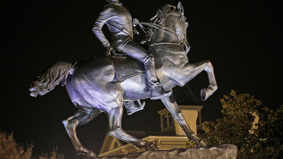 The statue titled Rumor's of War by artist Kehinde Wiley gets fully unveiled after the tarp covering the statue got stuck for a while at the Virginia Museum of Fine Arts in Richmond, Va., Tuesday, Dec. 10, 2019. The monumental bronze sculpture of a y