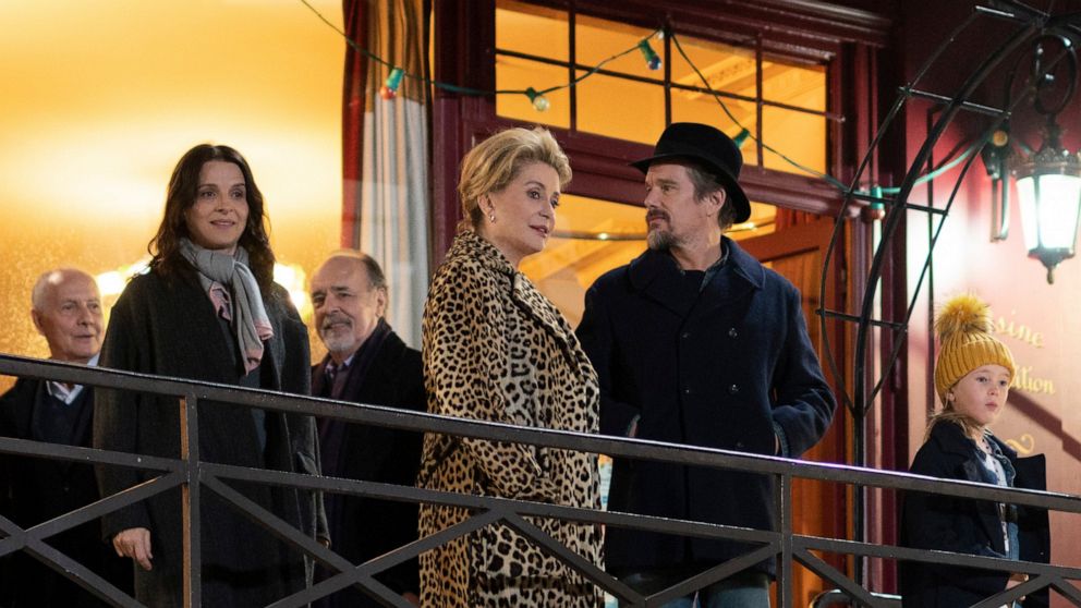 This image released by IFC Films shows, foreground from left, Juliette Binoche, Catherine Deneuve, Ethan Hawke and Clémentine Grenier in a scene from "The Truth." (IFC Films via AP)