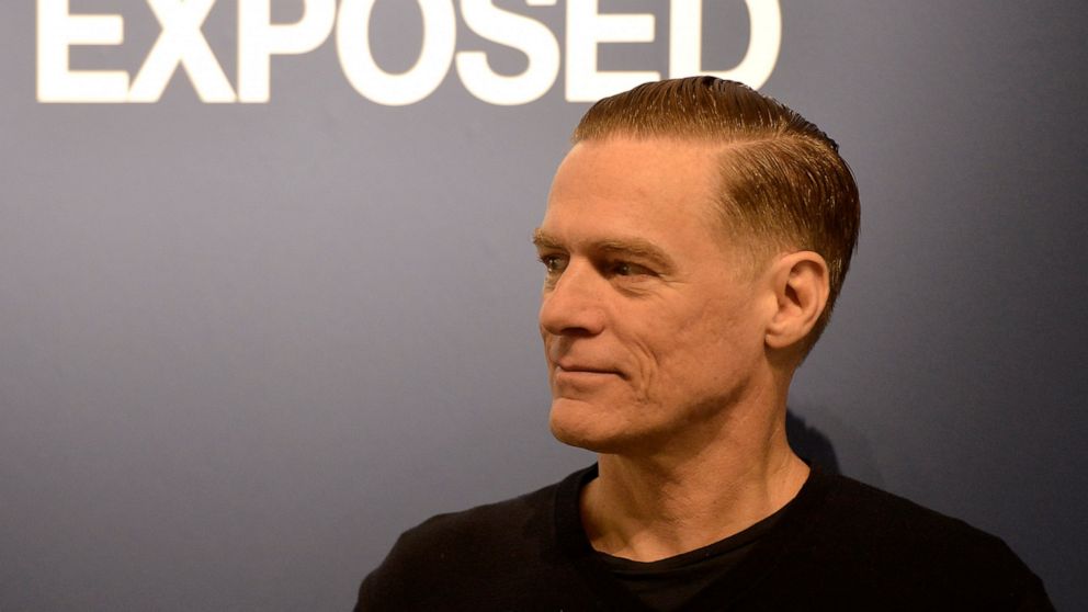 FILE - Canadian rock star Bryan Adams poses during the opening of his photo exhibition in Duesseldorf, Germany, on Feb. 1, 2013. Bryan Adams took a break Monday from his coronavirus quarantine in Milan to virtually unveil the 2022 Pirelli Calendar th