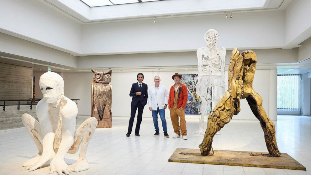 In this photo provided by Sara Hilden Art Museum, British artist Thomas Houseago, centre, poses with US actor Brad Pitt, centre right and Australian musician Nick Cave, prior to the opening of their joint exhibition, in Tampere, Finland, Saturday, Se