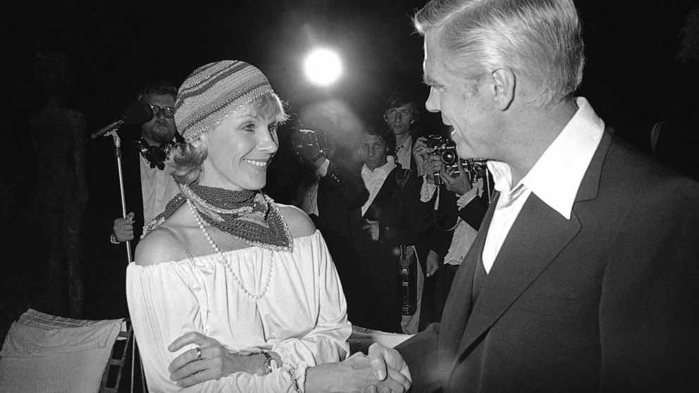 FILE - In this May 25, 1978 file photo, Swedish actress Bibi Andersson meets George Peppard at a party for the announcement of start of new U.S. film