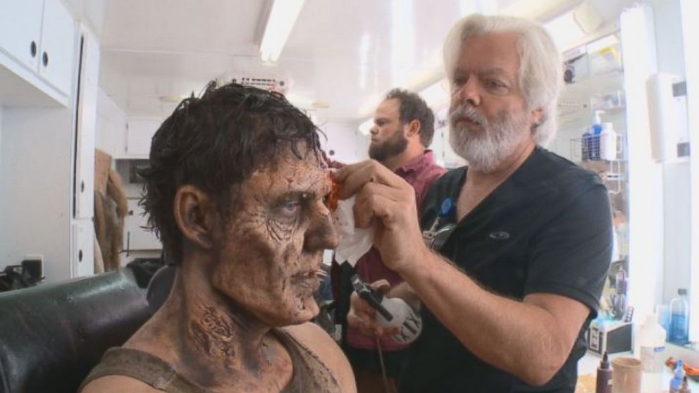 A "walker" gets ready in the make-up chair on the set of "The Walking Dead."
