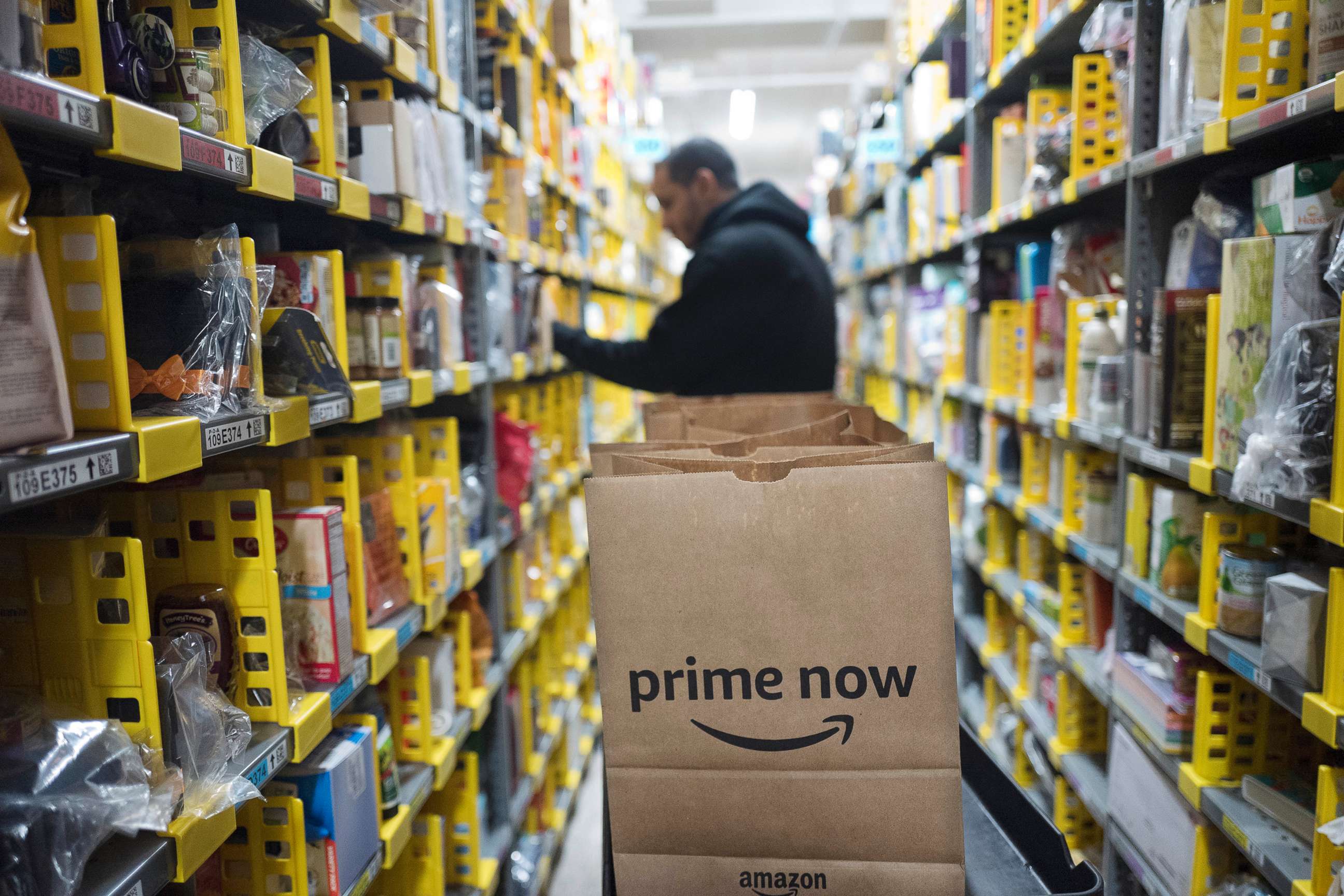 PHOTO: A clerk reaches to a shelf to pick an item for a customer order at the Amazon Prime warehouse in New York, Dec. 20, 2017.