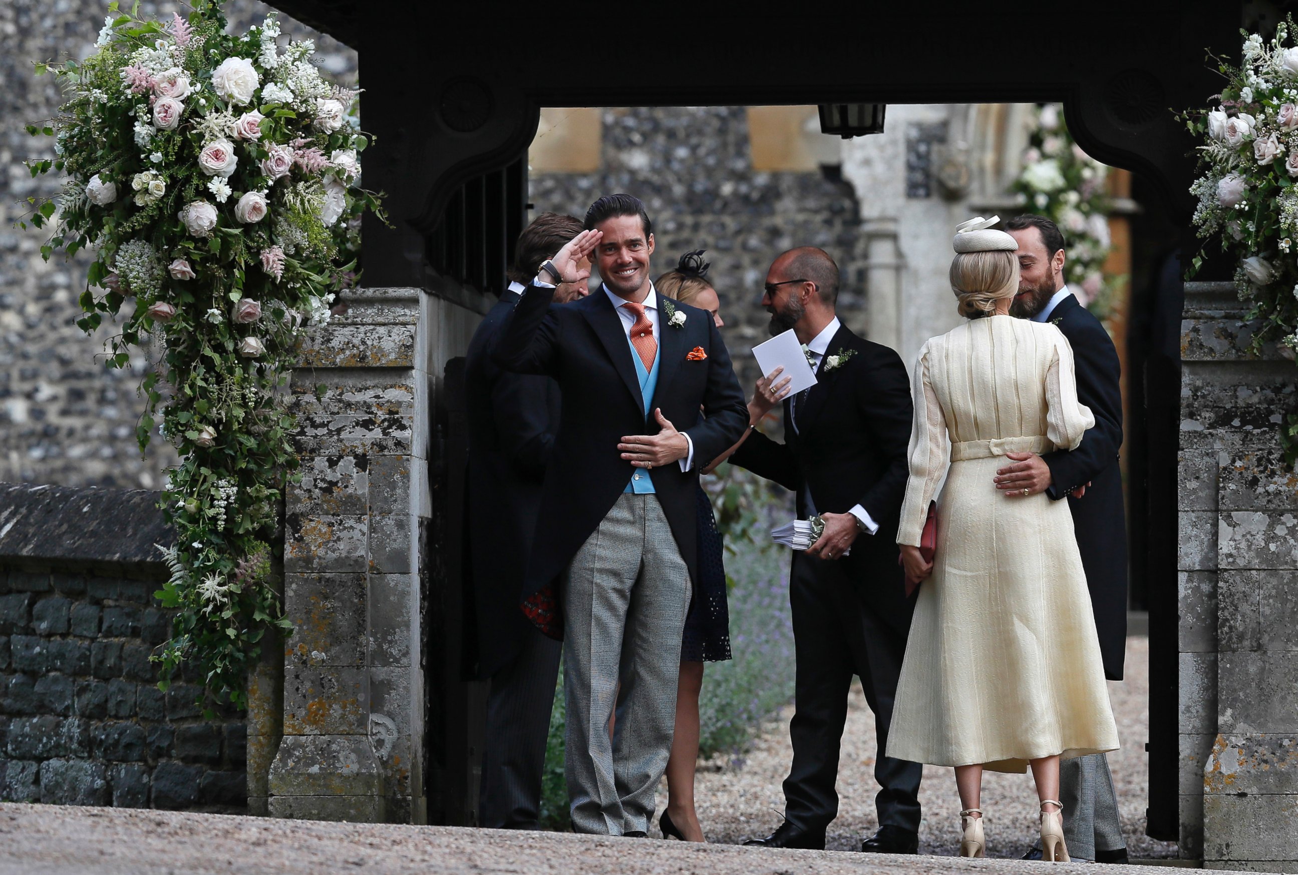 PHOTO: Spencer Matthews, left, gestures as he stands with James Middleton, right, and Donna Air at the entrance of St Mark's Church in Englefield, England, ahead of the wedding of Pippa Middleton and James Matthews, May 20, 2017.