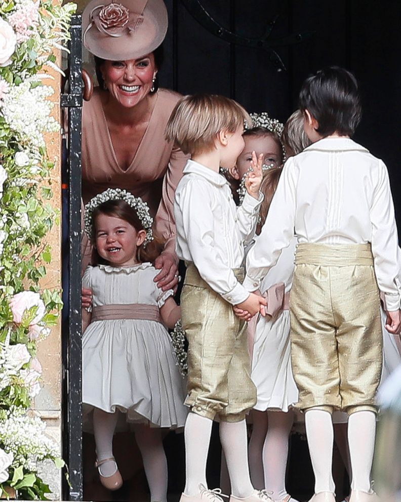 PHOTO: Kate, Duchess of Cambridge, left, stands with her daughter Princess Charlotte, bottom left, as they arrive for the wedding of Pippa Middleton and James Matthews at St Mark's Church in Englefield, May 20, 2017.