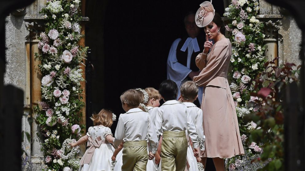 PHOTO: Catherine, Duchess of Cambridge, puts her finger over her lips as she walks with the bridesmaids and pageboys as they walk into at St Mark's Church in Englefield, England, May 20, 2017.