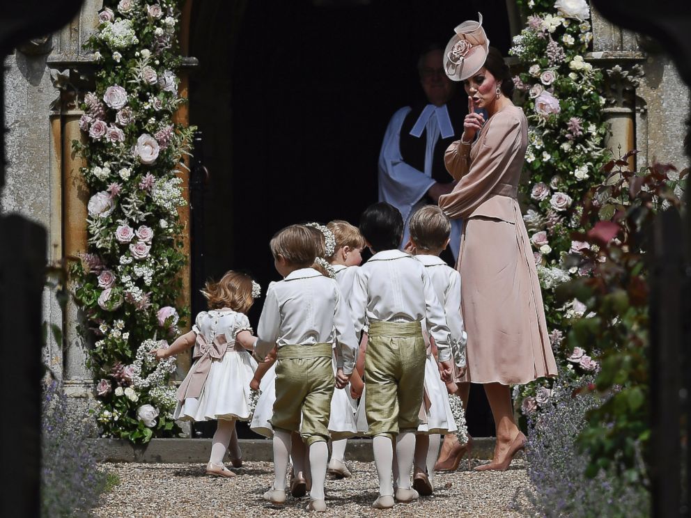 PHOTO: Catherine, Duchess of Cambridge, puts her finger over her lips as she walks with the bridesmaids and pageboys as they walk into at St Mark's Church in Englefield, England, May 20, 2017.