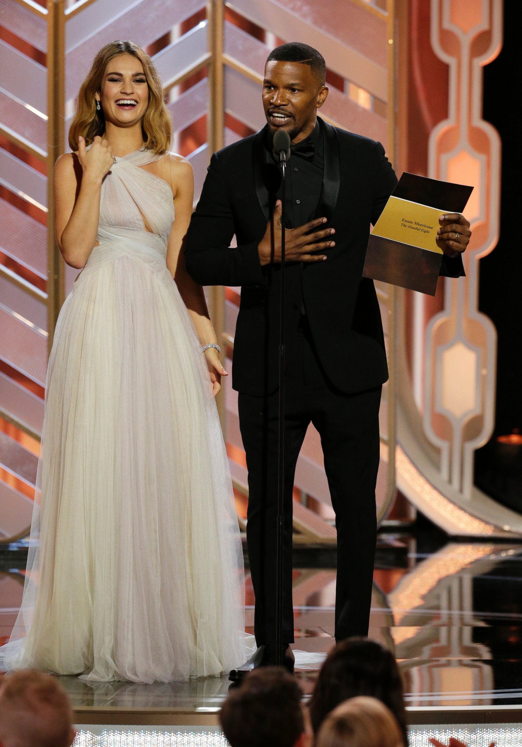 PHOTO: Lily James and  Jamie Foxx present an award at the 73rd Annual Golden Globe Awards at the Beverly Hilton Hotel in Beverly Hills, Calif., on Jan. 10, 2016.
