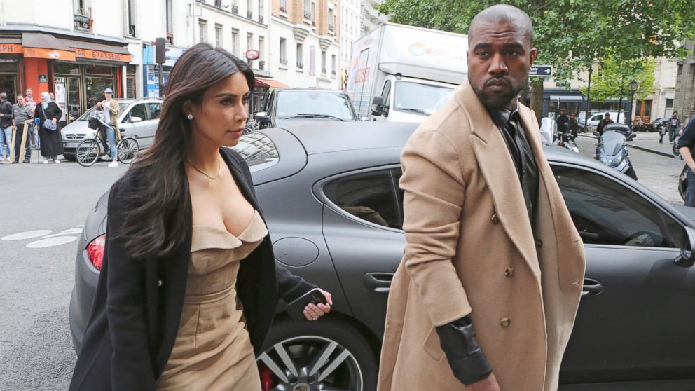 Kim Kardashian and Kanye West arrive at a luxury shop in Paris, Wednesday, May 21, 2014.
