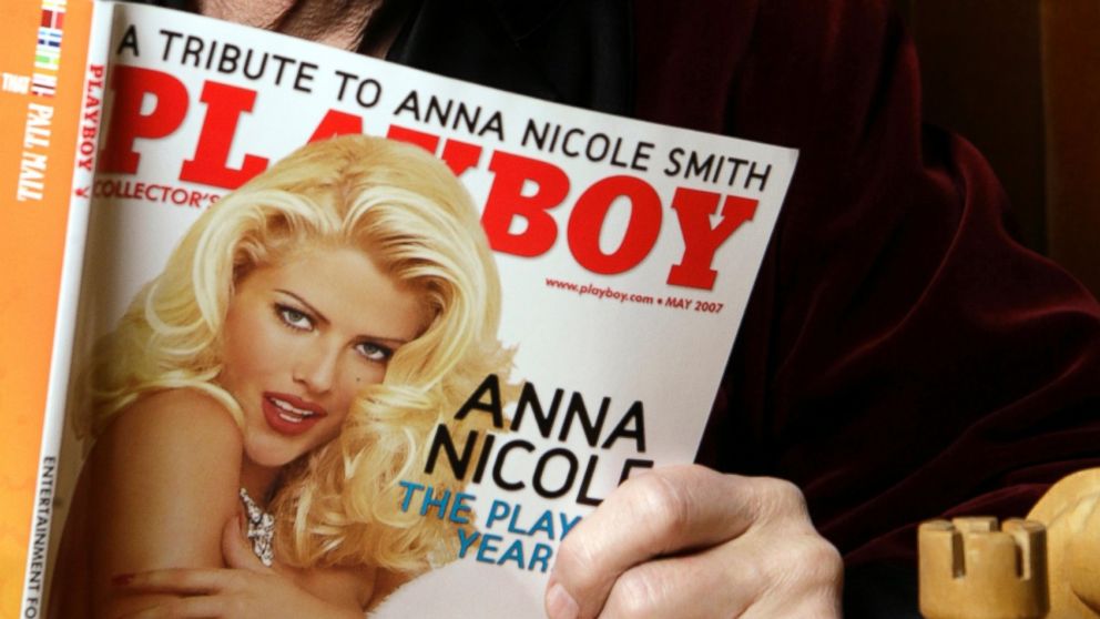Playboy Enterprises founder Hugh Hefner poses with a copy of Playboy magazine featuring Anna Nicole Smith as Playmate of the Year, at the Playboy Mansion in Los Angeles, April 5, 2007.