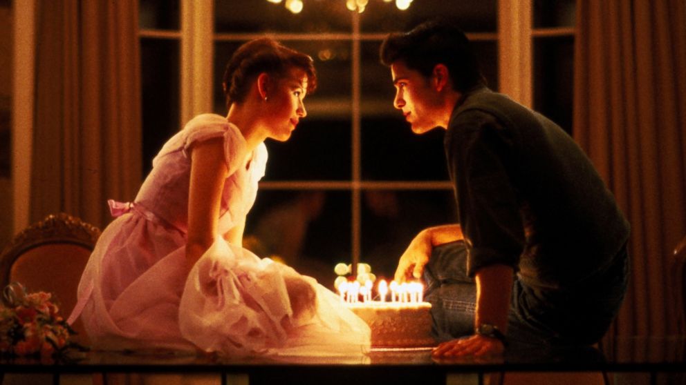 In this 1984 film publicity image released by Universal Pictures, Molly Ringwald, left, and Michael Schoeffling are shown in a scene from "Sixteen Candles." 