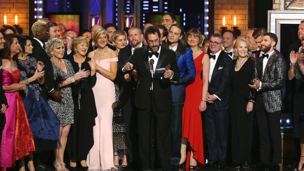 Playwright Tony Kushner, center, and the cast and crew of "Angels in America" accept the award for best revival of a play at the 72nd annual Tony Awards at Radio City Music Hall on Sunday, June 10, 2018, in New York. 